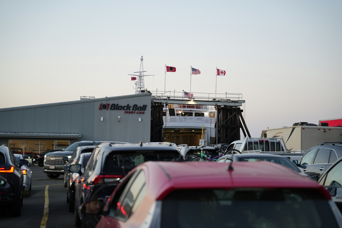 Cars loading onto European ferry showing organized vehicle transport and boarding procedures