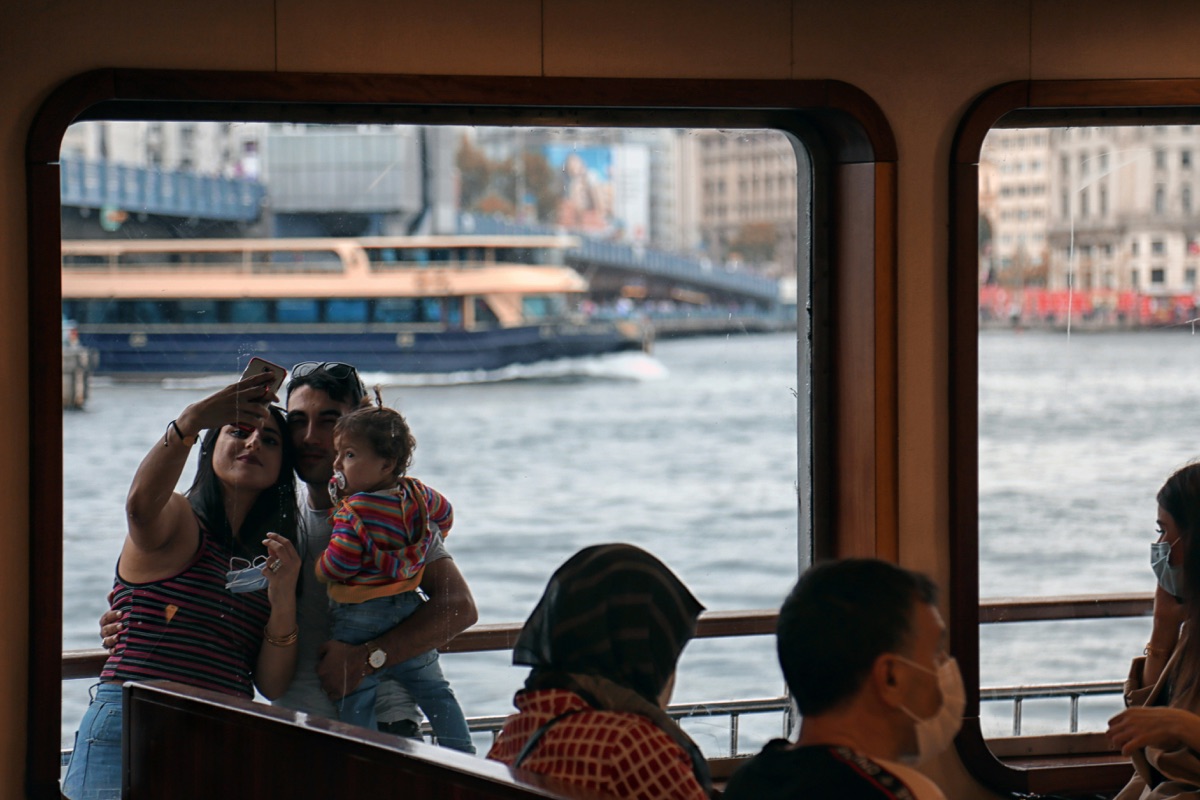 Happy family enjoying ferry travel with children playing safely on deck during European crossing
